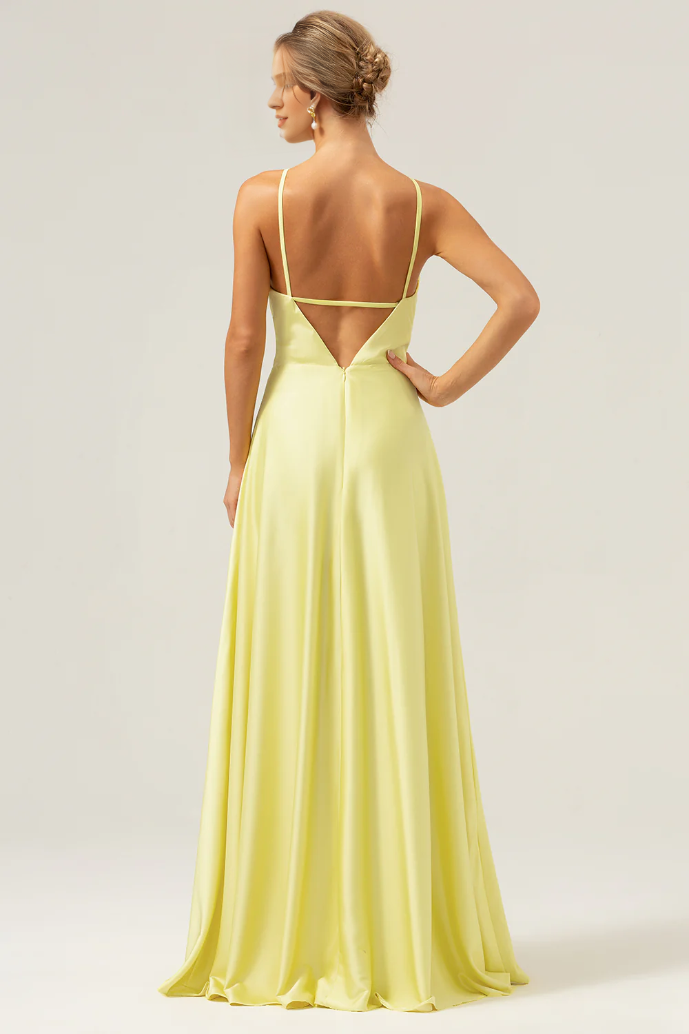 Yellow A-line hanging neck, exposed back, and floor length bridesmaid dress with flowers