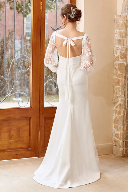 White fishtail long sleeved and floor length wedding dress