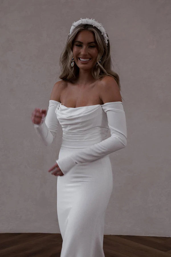 Unique off the shoulder long sleeved Bohemian style satin wedding dress paired with court train